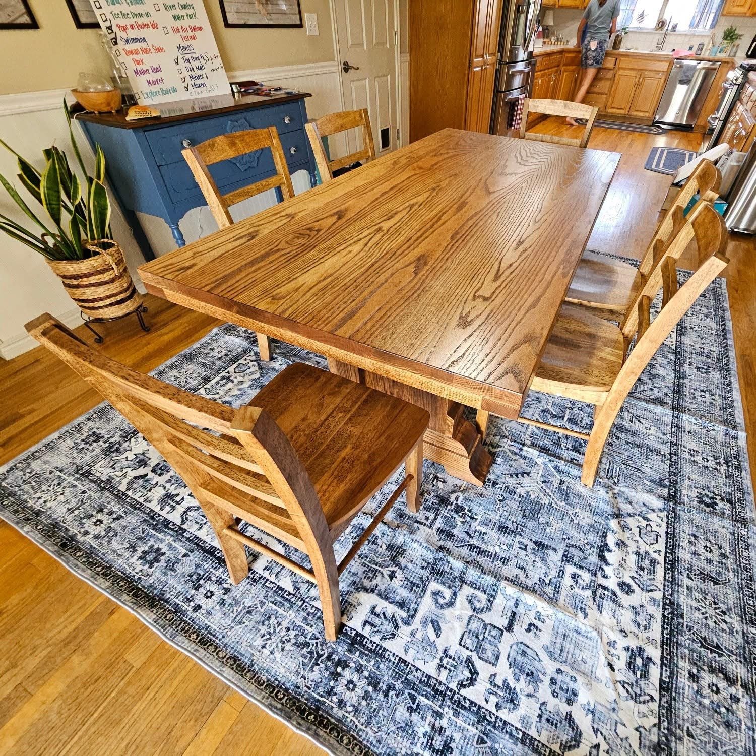 Custom oak dining table with matching chairs in a home dining room by Westerman Woodworks, Tulsa, Oklahoma